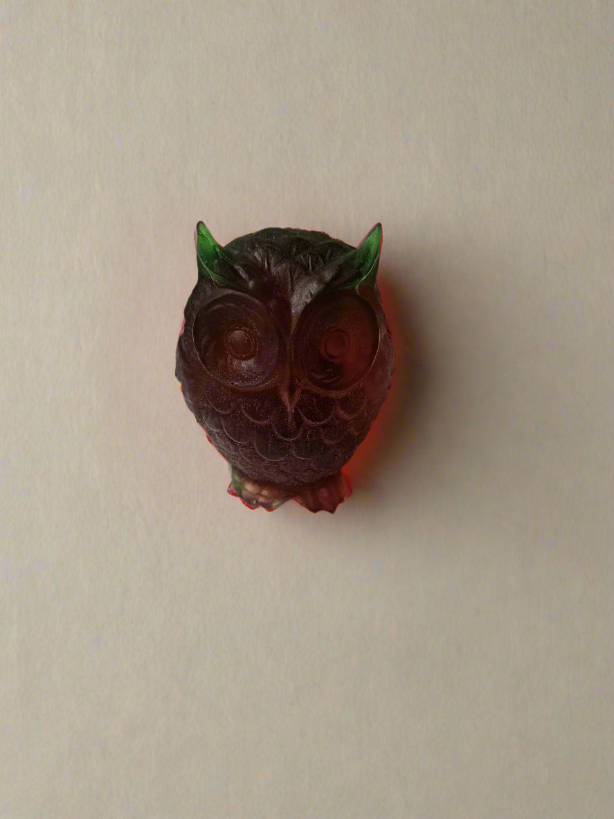 red and green owl-shaped soap on a neutral background